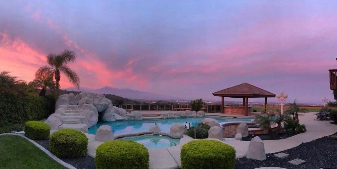Poolside venue — pink-sunset pool panorama
