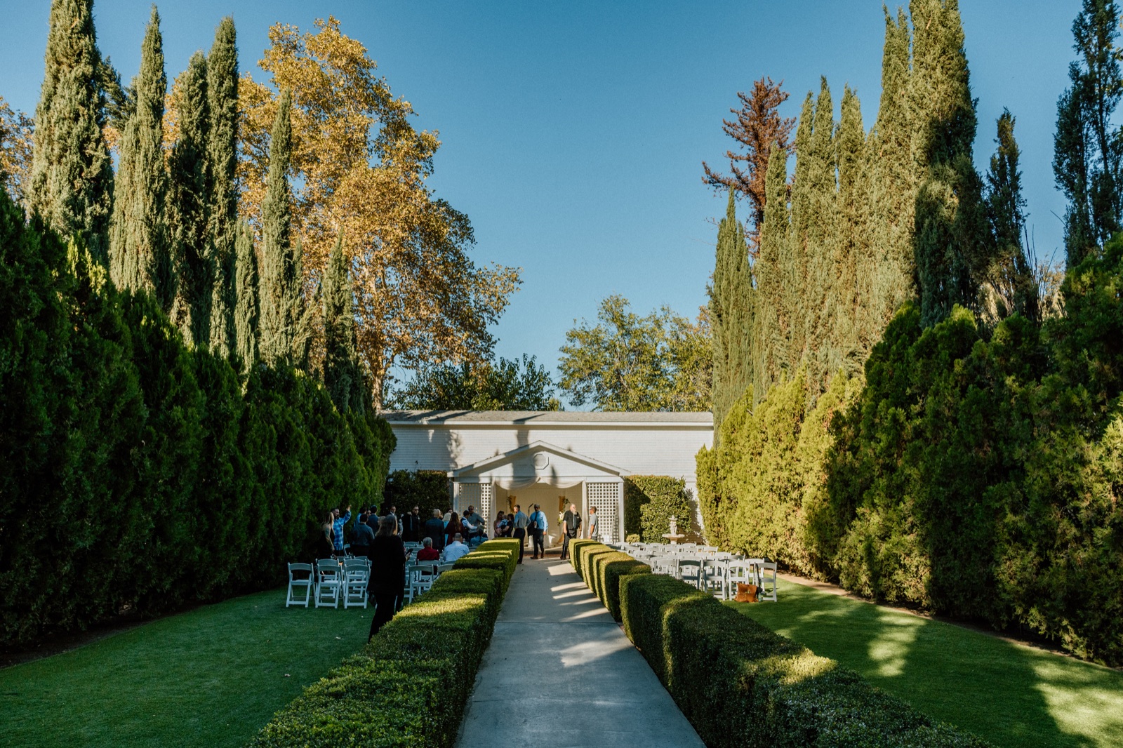 Thatcher Manor — garden grounds with hedges and pathway